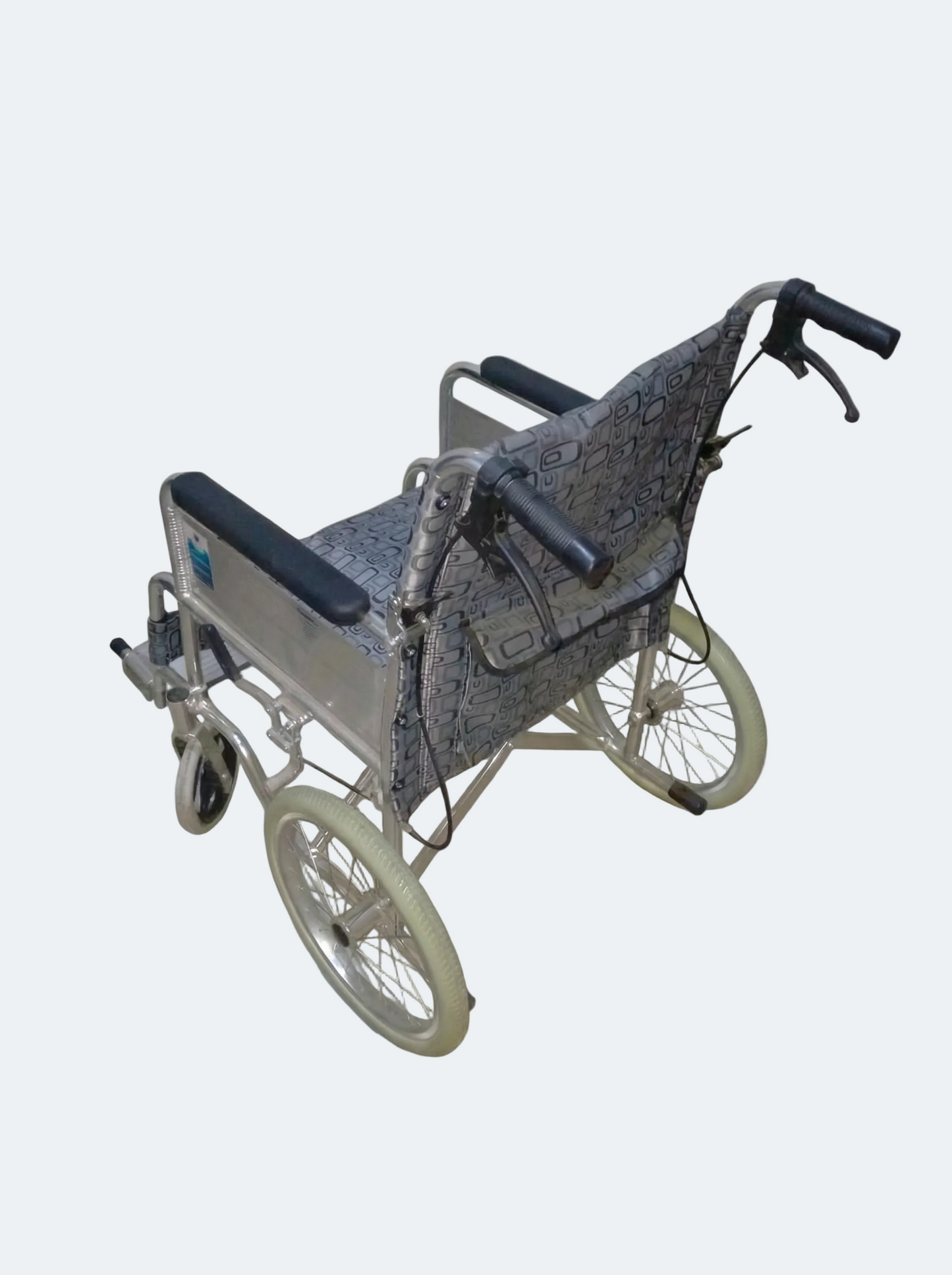 Wheelchair with a patterned cover on a white background