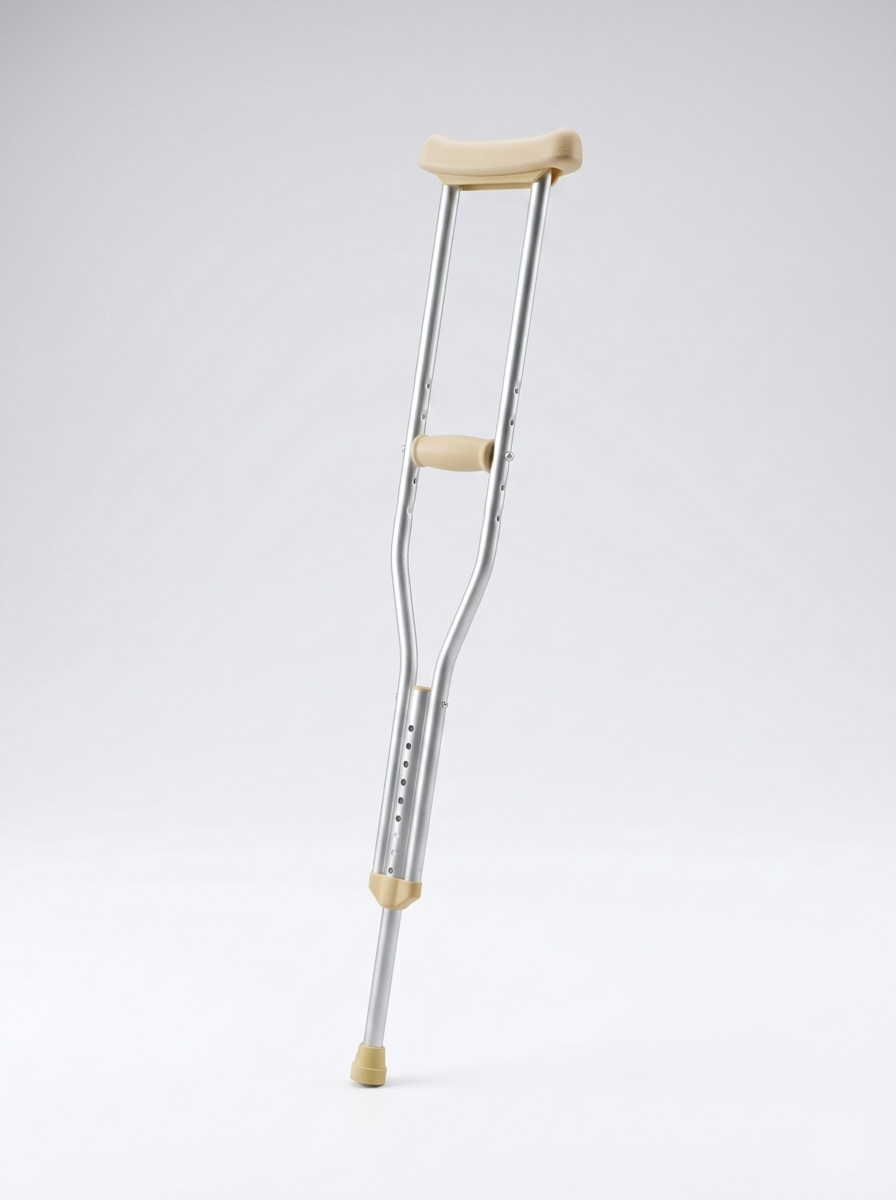 Crutch with beige grips on a light gray background