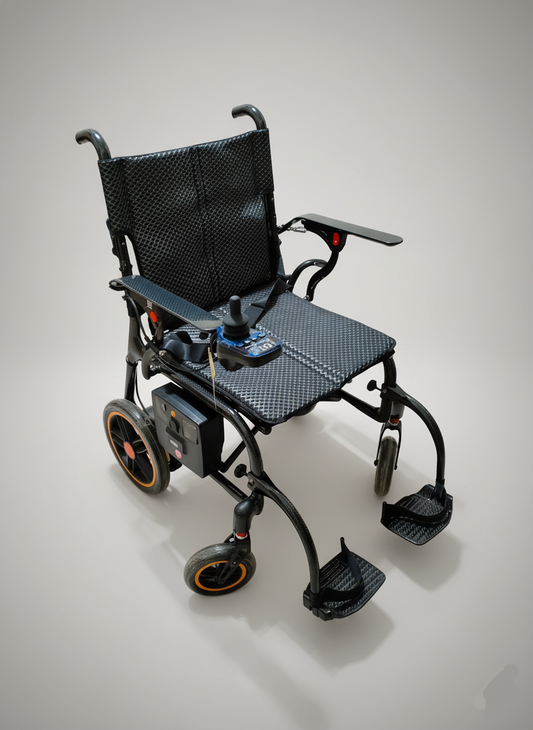 Black electric wheelchair on a gray background
