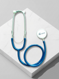 Blue and green stethoscope on a white surface with 'UG Care' branding.